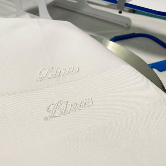 Broderar namn på vita klassiska servetter. Jag bygger upp broderiet lite extra med tråd för att få fin skuggeffekt då broderiet är vitt på vit servett. Kundanpassat hos Gyllene Trtåden.